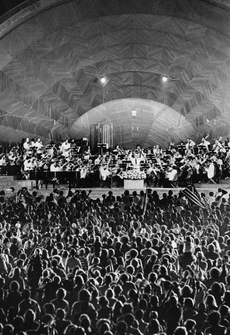 Arthur Fiedler conducts the Boston Pops in a concert at the Hatch Shell on the Charles River Esplanade during Boston's Fourth of July celebration on July 4, 1976.