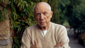 MOUGINS, FRANCE - 1966 : Pablo Picasso standing by a green fern with folded arms, wearing a cashmere sweater. (Photo by Tony Vaccaro / Getty Images)