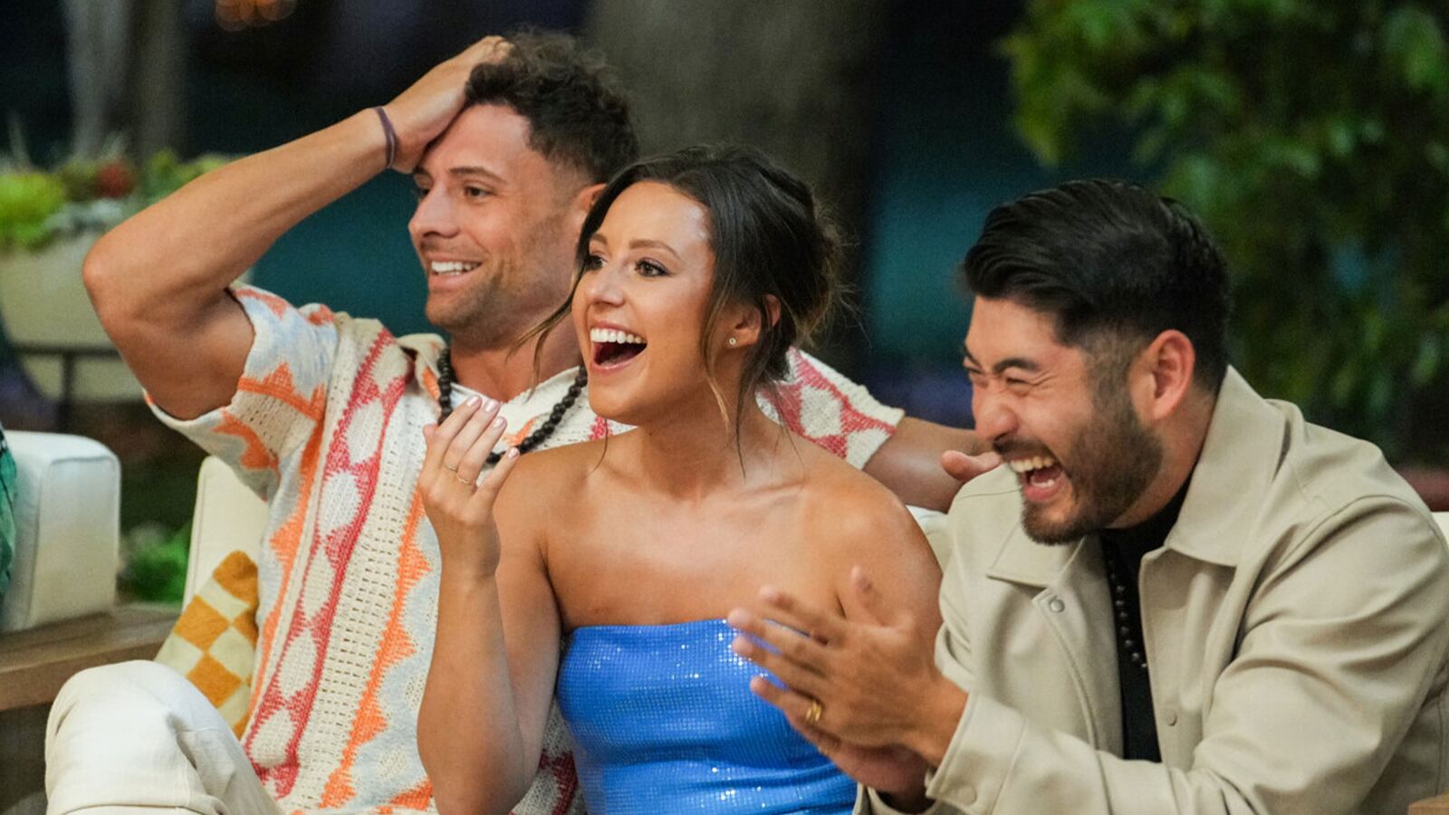 Alt: Katie Thurston laughs on a sofa with contestants on ‘F Boy Island’