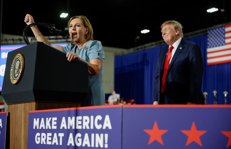 U.S. President Donald Trump reacts while U.S. Senator Darline Graham (R-SC) speaks during a campaign rally for her at the Myrtle Beach Convention Center in Myrtle Beach, South Carolina, U.S., August 21, 2026.