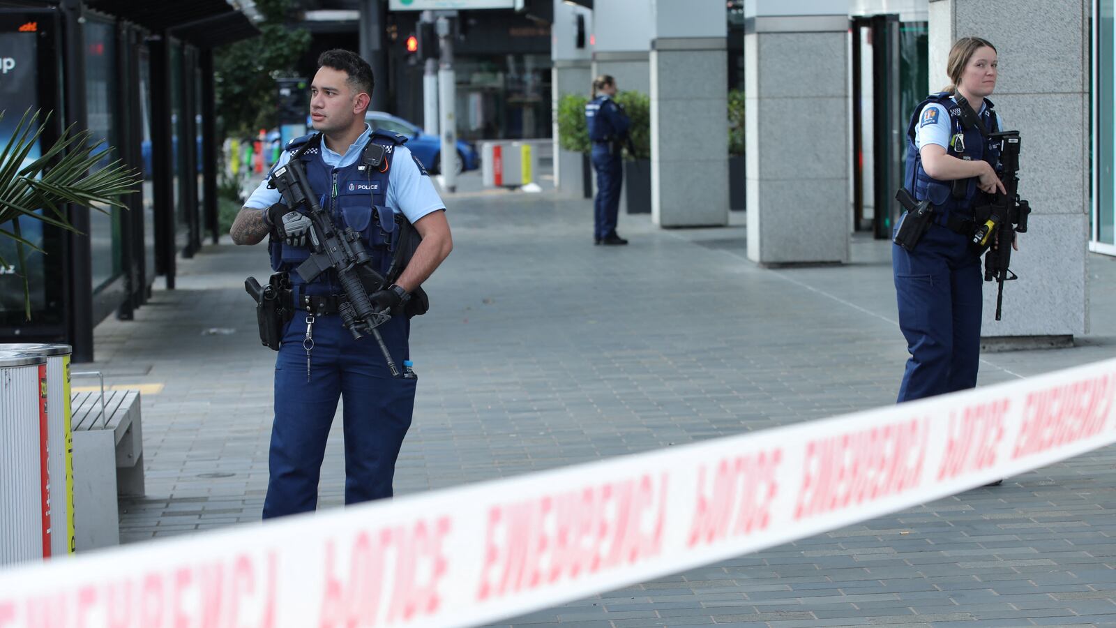Police officers stand guard near the location of a reported shooting in Auckland, New Zealand, on July 20, 2023.