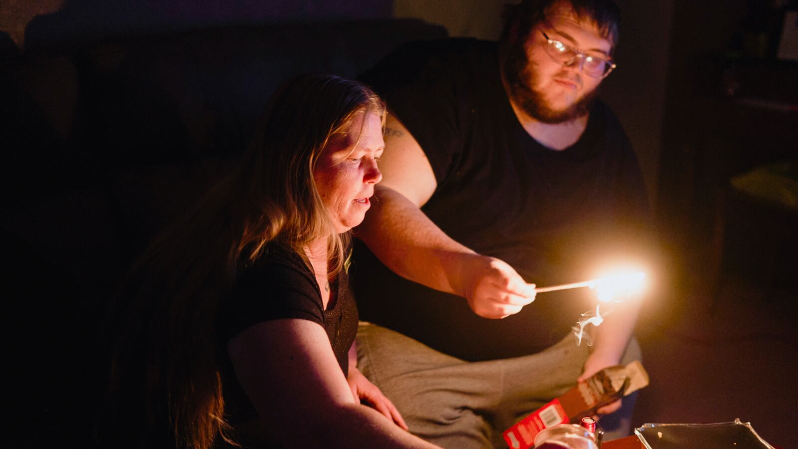 Christina Beverly and John Shearon light candles in their home after weather caused electricity blackouts and boil water notices in Fort Worth, Texas, U.S. February 20, 2021.