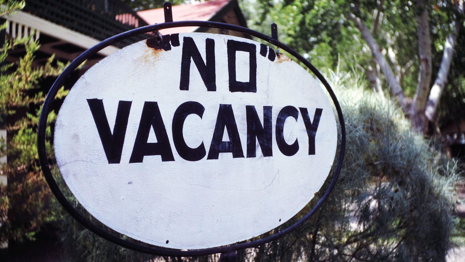 A photo including a No Vacancy sign