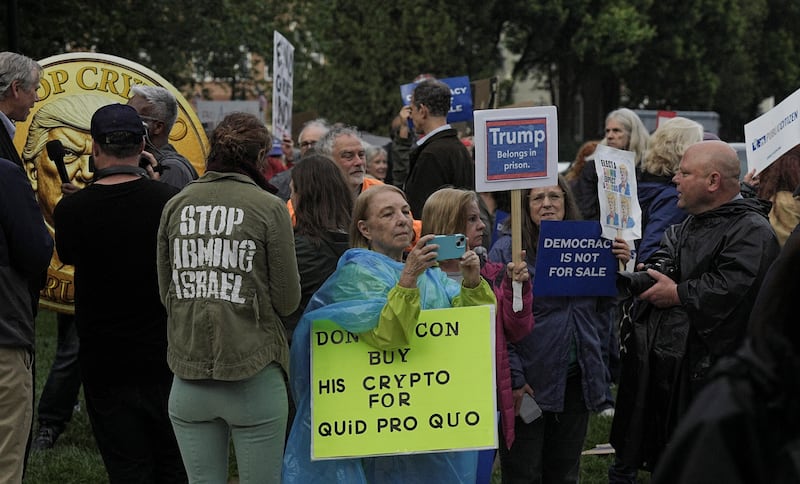 Demonstrators gather outside Trump National Golf Course ahead of U.S. President Donald Trump’s meme coin gala in Sterling, Virginia, U.S., May 22, 2025. REUTERS/Ken Cedeno