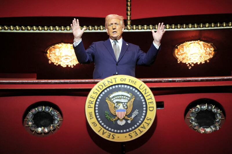 Donald Trump gestures while he poses for a picture at the presidential box at the Kennedy Center, in Washington, D.C., U.S., March 17, 2025.