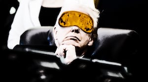 Donald Trump wearing a sleep mask while in a meeting.