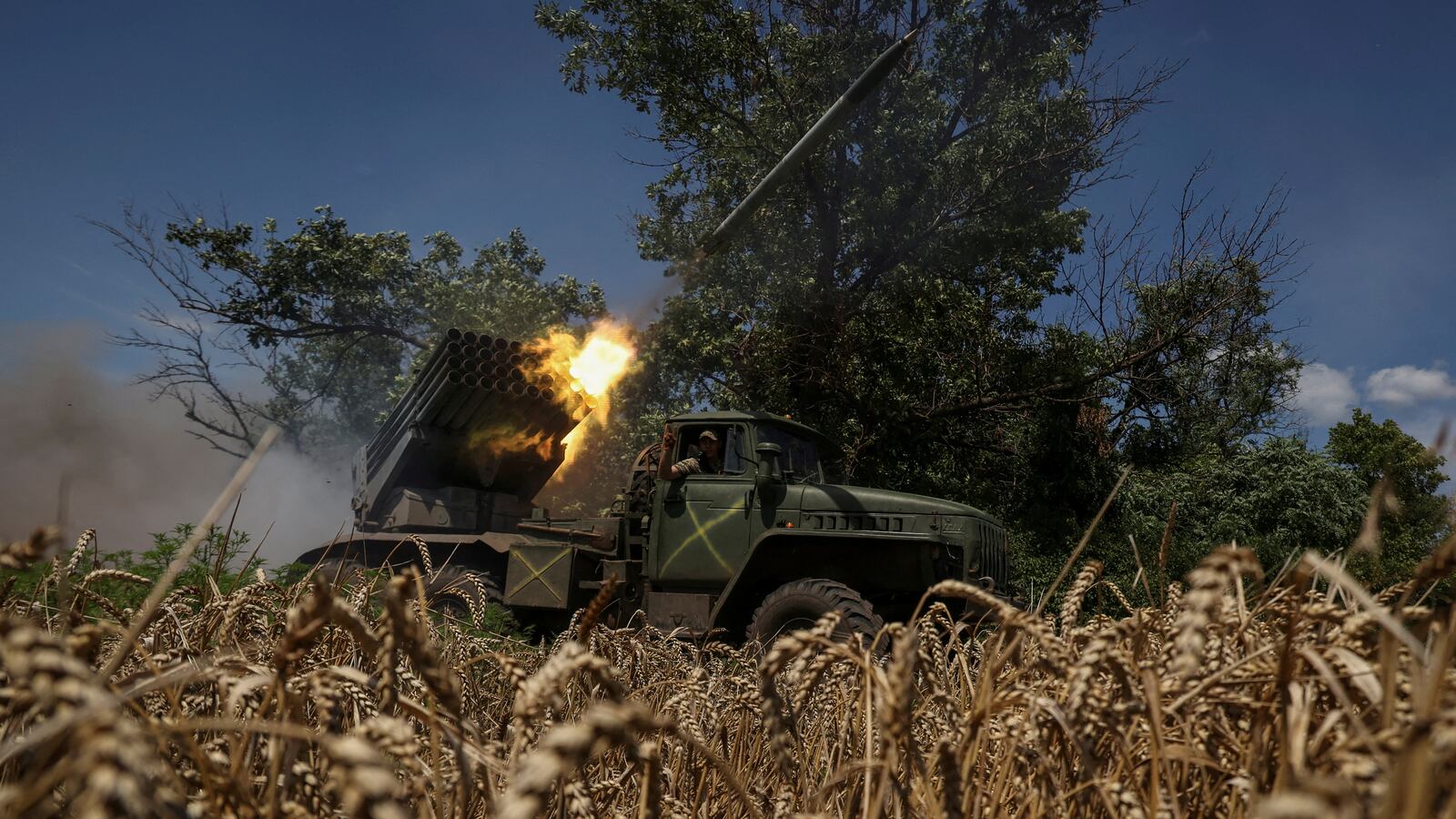 Ukrainian servicemen fire multiple launch rocket system during the war against Russian invaders.