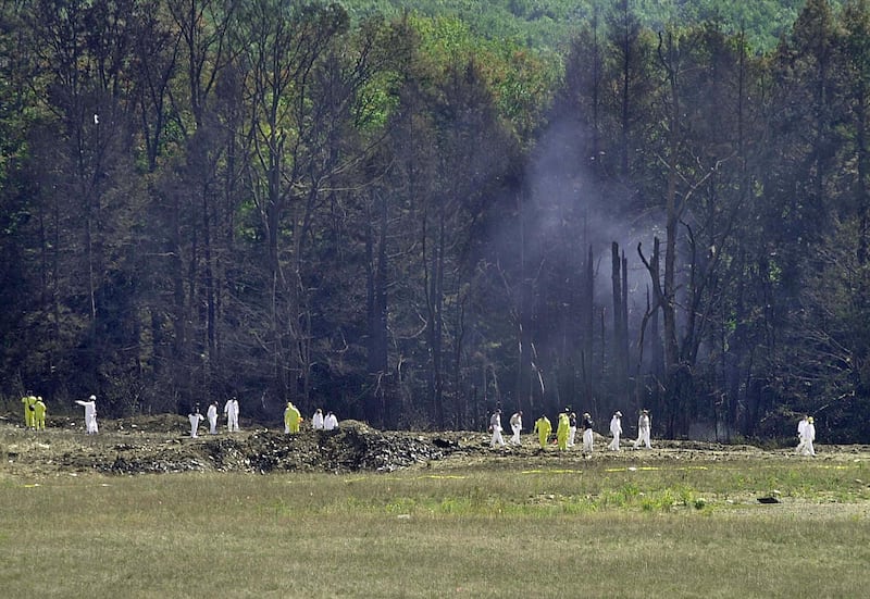 Investigative personnel search the crash site of United Airlines Flight 93 looking for debris and evidence, including the plane's flight recorder, 12 September 2001 in Shanksville, Pennsylvania. The hijacked plane crashed killing all 45 people on board. AFP PHOTO/David MAXWELL (Photo by DAVID MAXWELL / AFP) (Photo by DAVID MAXWELL/AFP via Getty Images)