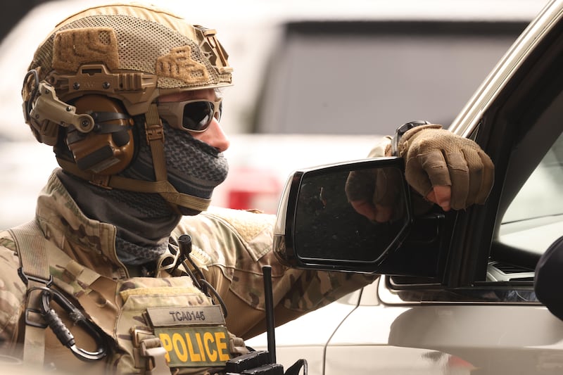 WILLOWBROOK,  CA  - JANUARY 21, 2026  A Federal agent looks on as his colleagues investigate a shooting involving a federal agent on Wednesday morning in Willowbrook on January 21, 2026. It
prompted a large response from local and federal authorities. A spokesperson for the Los Angeles County Sheriff's Department said the U.S. Border Patrol or Department of Homeland Security was involved in the shooting near the intersection of 126th Street and Mona Boulevard. Shortly before 7:30 a.m., the Border Patrol informed the Sheriff's Department that the agency was conducting an operation in the area, according to the LASD. The shooting occurred shortly afterward. Genaro Molina/Los Angeles Times via Getty Images)