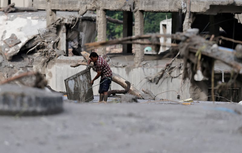A man salvages his belongings from mud following devastating floods, in Trishuli, Nuwakot district, Nepal, August 27, 2026. REUTERS/Navesh Chitrakar