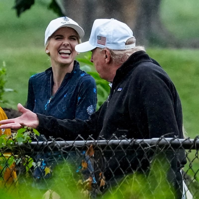 U.S. Interior Secretary Doug Burgum and Executive assistant to U.S. President Donald Trump Natalie Harp speak with Donald Trump during a visit at a golf course at Hains Point in Washington, D.C., U.S., June 28, 2026.
