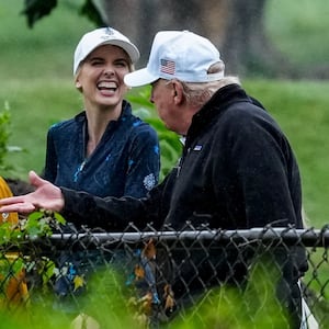 U.S. Interior Secretary Doug Burgum and Executive assistant to U.S. President Donald Trump Natalie Harp speak with Donald Trump during a visit at a golf course at Hains Point in Washington, D.C., U.S., June 28, 2026.