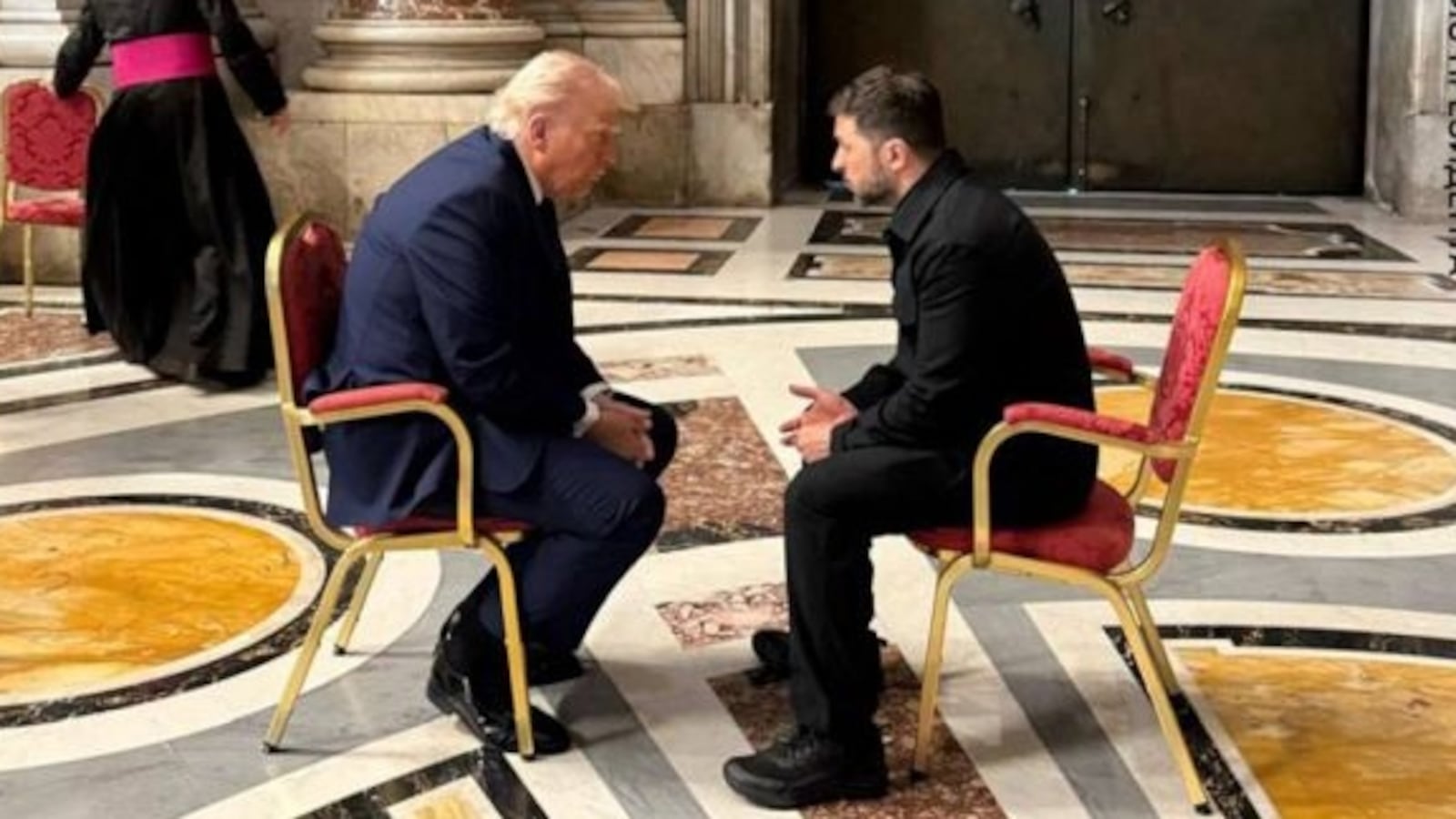 Trump and Zelensky hunched over in discussion at the funeral of Pope Francis