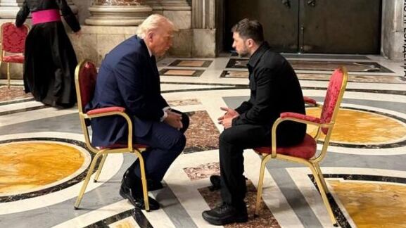 Trump and Zelensky hunched over in discussion at the funeral of Pope Francis