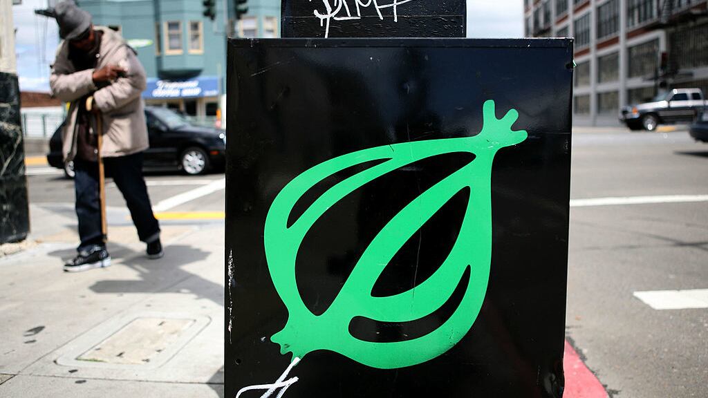 A pedestrian walks by an Onion news rack May 5, 2009, in San Francisco, California.
