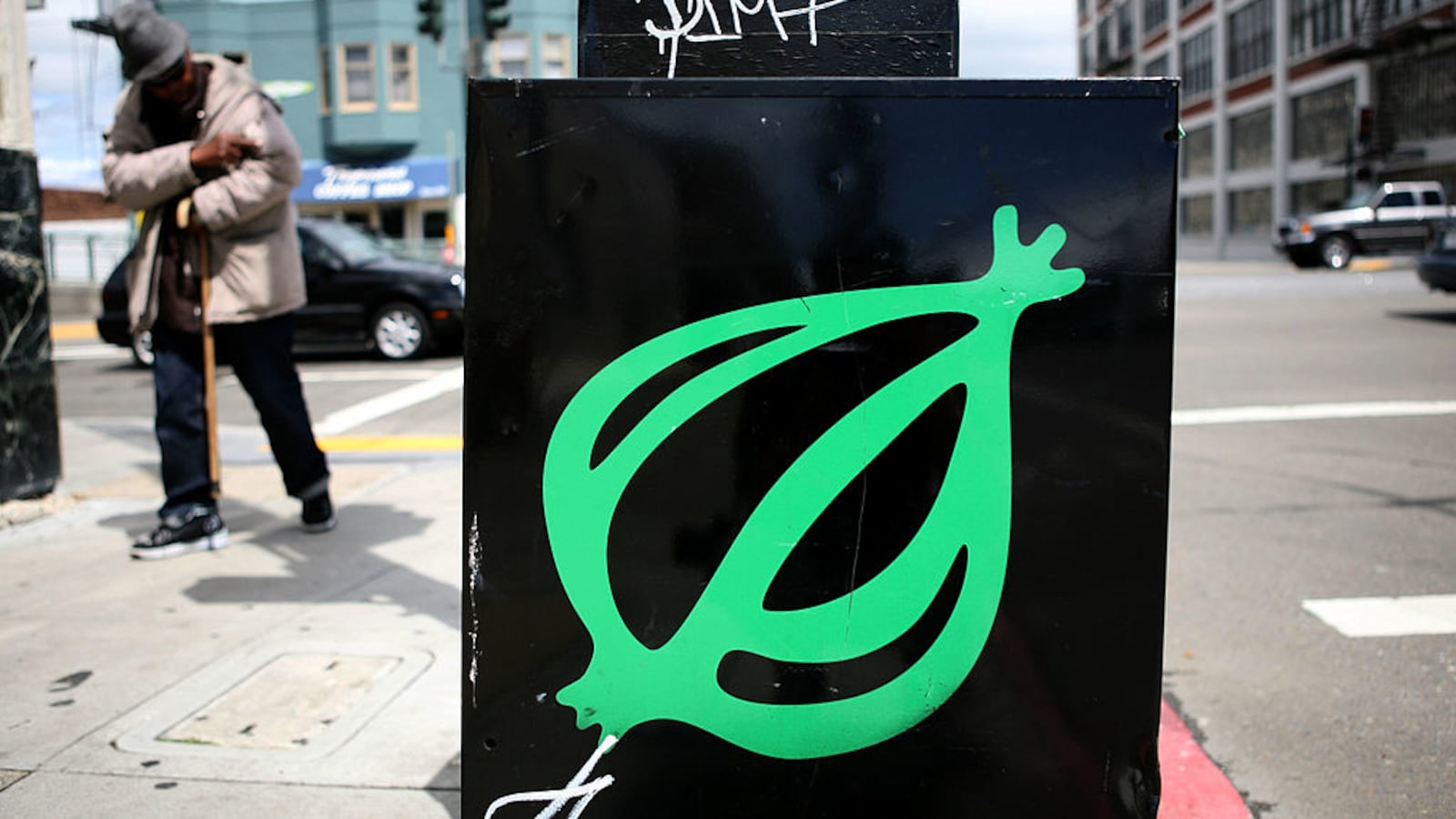 A pedestrian walks by an Onion news rack May 5, 2009, in San Francisco, California.