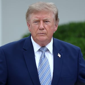 WASHINGTON, DC - AUGUST 20: U.S. President Donald Trump (C) speaks with guests during an event announcing the expansion of a foster care initiative in the Rose Garden of the White House on August 20, 2026 in Washington, DC. The event focused on the first lady's “Foster the Future” initiative, with plans to expand opportunities for individuals transitioning from foster care. (Photo by Finn Gomez/Getty Images)