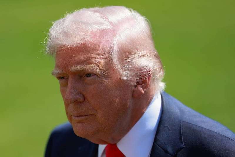 Donald Trump looks on