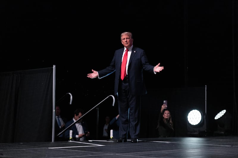 Republican presidential nominee, former President Donald Trump takes the stage for an interview with Tucker Carlson during his Live Tour at the Desert Diamond Arena on October 31, 2024 in Phoenix, Arizona.