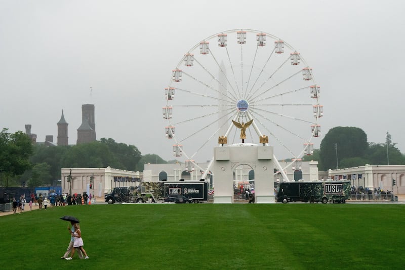 Visitors attend The Great American State Fair in the rain on the National Mall in Washington, D.C., U.S., June 28, 2026.