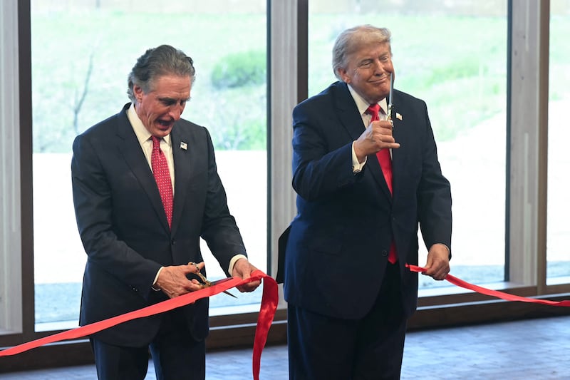US Secretary of the Interior Doug Burgum (L) and US President Donald Trump take part in a ribbon cutting during a ceremony at the newly opened Theodore Roosevelt Presidential Library in Medora, North Dakota, on July 1, 2026. (Photo by SAUL LOEB / AFP via Getty Images)