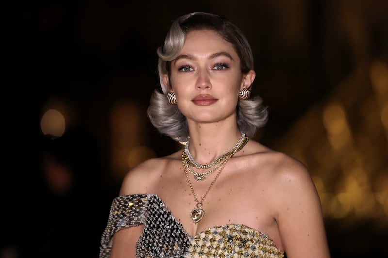 Gigi Hadid poses during a photocall as she arrives to attend "Le Grand Diner du Louvre" to mark the first fashion exhibition "Louvre Couture: Art and Fashion - Statement Pieces" at the Louvre Museum in Paris, France, on March 4, 2025.