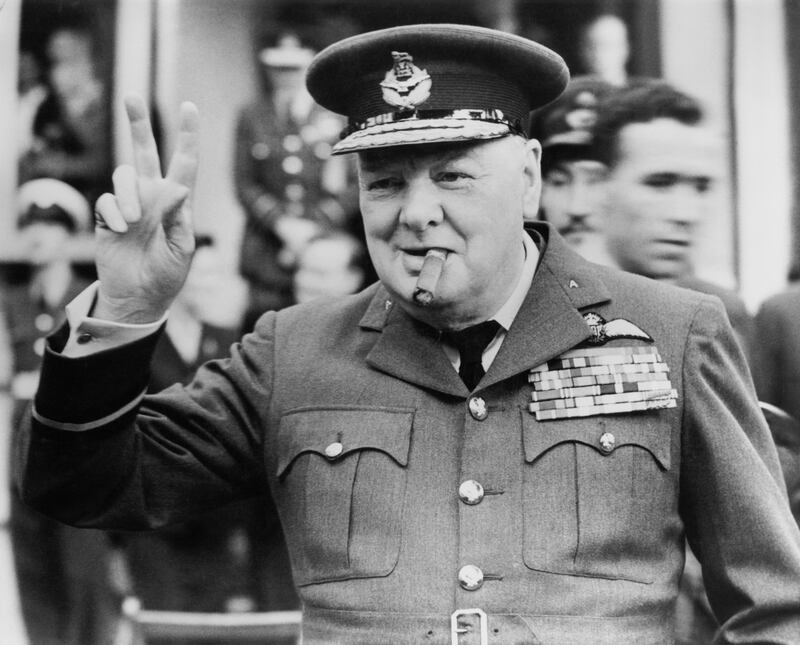 Winston Churchill gives his famous v-sign as he opens the new headquarters of 615 (County of Surrey) Squadron of the RAAF (Royal Auxiliary Air Force) at Croydon, 1948. (Photo Press/Hulton Archive/Getty Images)