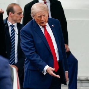 U.S. President Donald Trump examines the north columns of the White House, while returning from a Memorial Day event at Arlington National Cemetery, in Washington, D.C., U.S., May 25, 2026. REUTERS/Nathan Howard