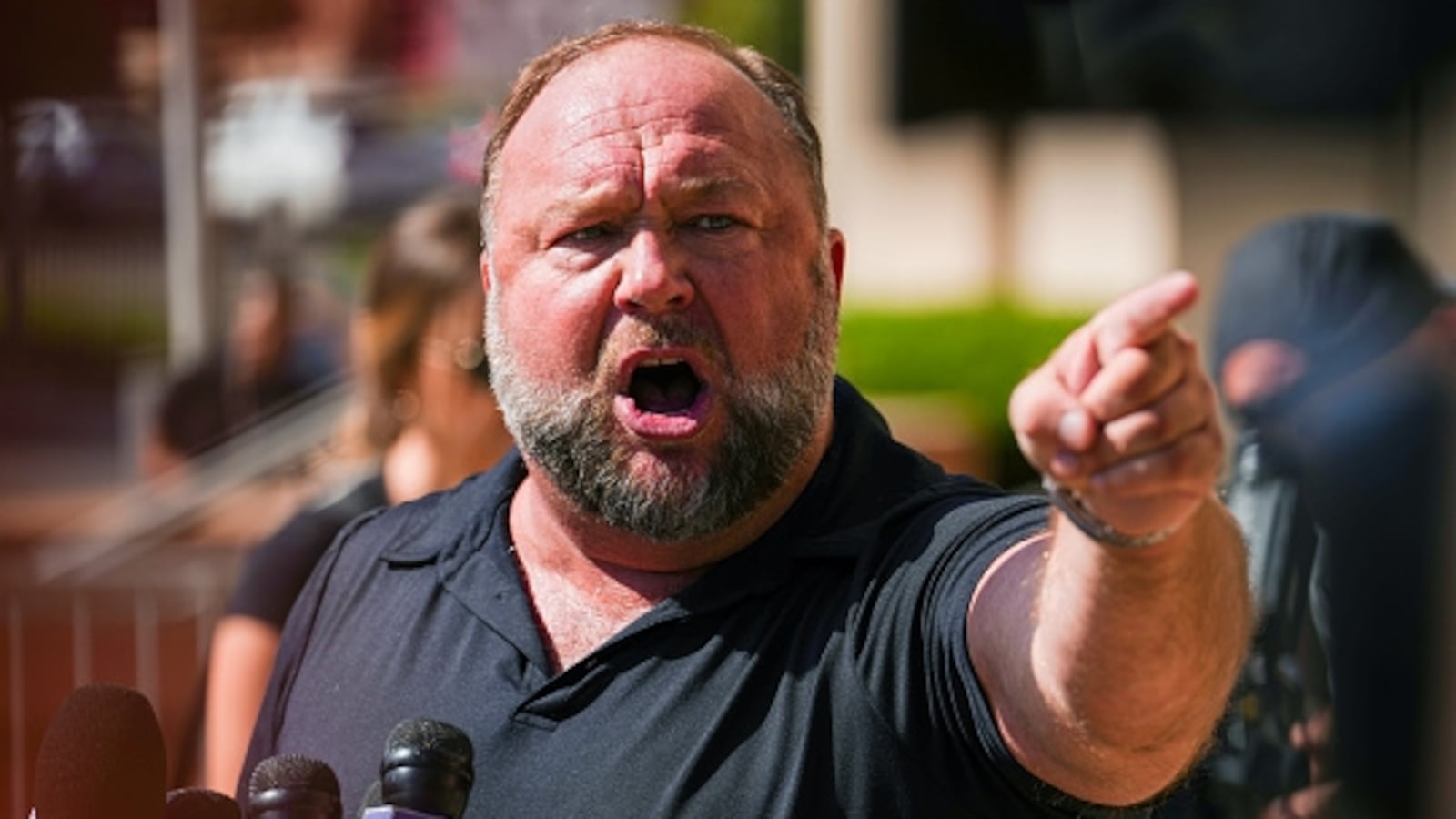 WATERBURY, CONNECTICUT - SEPTEMBER 21: InfoWars founder Alex Jones speaks to the media outside Waterbury Superior Court during his trial on September 21, 2022 in Waterbury, Connecticut. Jones is being sued by several victims' families for causing emotional and psychological harm after they lost their children in the Sandy Hook massacre. A Texas jury last month ordered Jones to pay $49.3 million to the parents of 6-year-old Jesse Lewis, one of 26 students and teachers killed in the shooting in Newtown, Connecticut. (Photo by Joe Buglewicz/Getty Images)