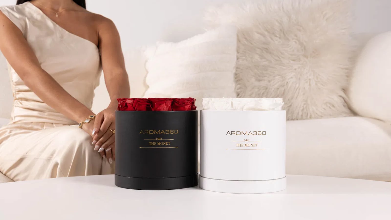 Aroma360 Monet Scent Diffusers displayed in black and white bases with preserved red and white roses, styled in a modern living room as an elegant Valentine’s Day gift and decorative home fragrance diffuser.