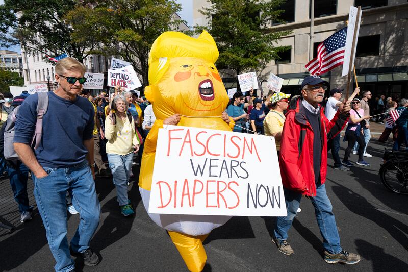 Protesters march down Pennsylvania Avenue NW for the second "No Kings" protest in Washington on Saturday, October 18, 2025 in Washington, DC.