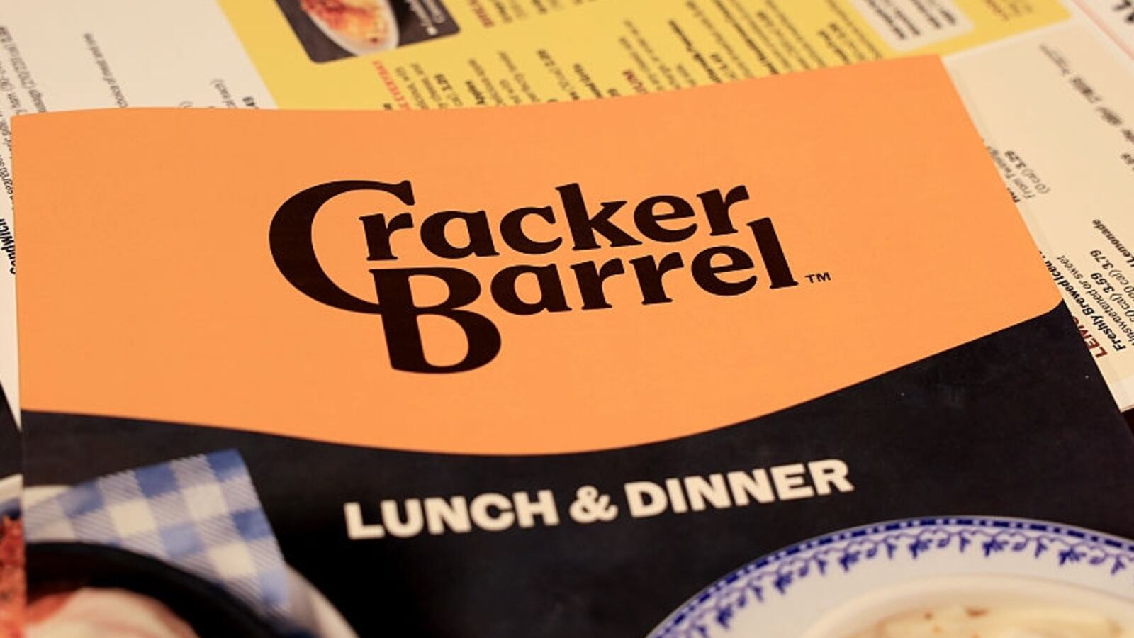 The new Cracker Barrel logo is seen on a menu inside the restaurant on August 21, 2025 in Pembroke Pines, Florida. The restaurant unveiled a new logo earlier this week as part of a larger brand refresh. The new logo removes the image of a man sitting next to a barrel and the phrase “old country store”. Now the logo will feature the words “Cracker Barrel” against a yellow background.