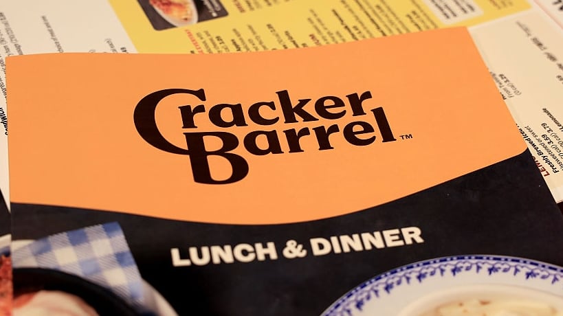 The new Cracker Barrel logo is seen on a menu inside the restaurant on August 21, 2025 in Pembroke Pines, Florida. The restaurant unveiled a new logo earlier this week as part of a larger brand refresh. The new logo removes the image of a man sitting next to a barrel and the phrase “old country store”. Now the logo will feature the words “Cracker Barrel” against a yellow background.
