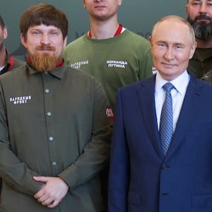In this pool photograph taken on September 19, 2024 and distributed by the Russian state agency Sputnik, Russian President Vladimir Putin, Vladimir Tkachuk (2L), co-founder of Yekaterinburg-based drone manufacturer Uraldronzavod, and other participants pose for a photo during the Russian leader's visit to the Special Technology Centre in Saint Petersburg. The CEO of a Russian drone factory has been seriously wounded in a "car explosion", Russian state media reported on August 5, 2026, in what appeared to be a second assassination attempt on a Russian defence official in days. (Photo by Gavriil Grigorov / POOL / AFP via Getty Images)