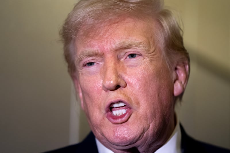 President Donald Trump speaks to members of the media aboard Air Force One while flying from Palm Beach International Airport on February 16, 2026.