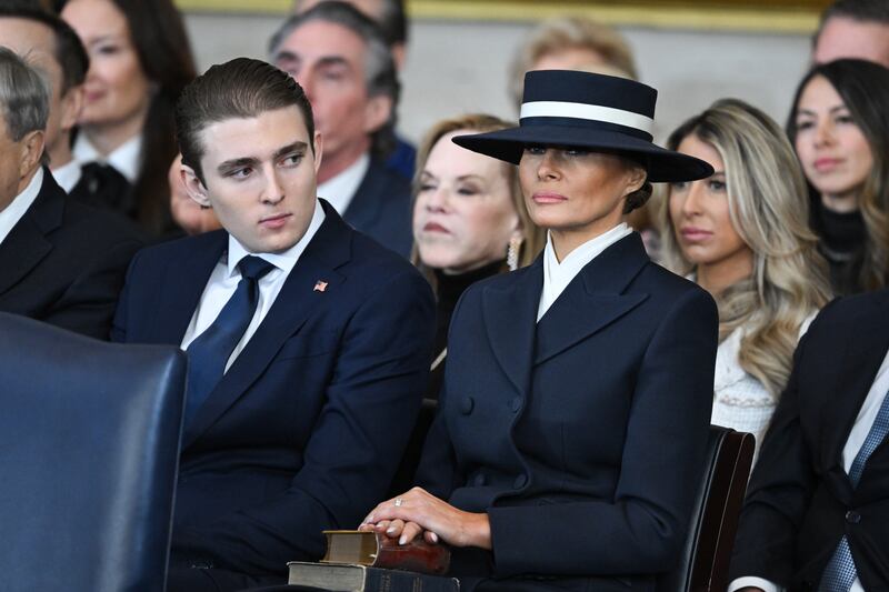 WASHINGTON, DC - JANUARY 20: Barron Trump and first lady Melania Trump listen as President Donald Trump gives his inaugural address in the U.S. Capitol Rotunda on January 20, 2025 in Washington, DC. Donald Trump takes office for his second term as the 47th president of the United States.