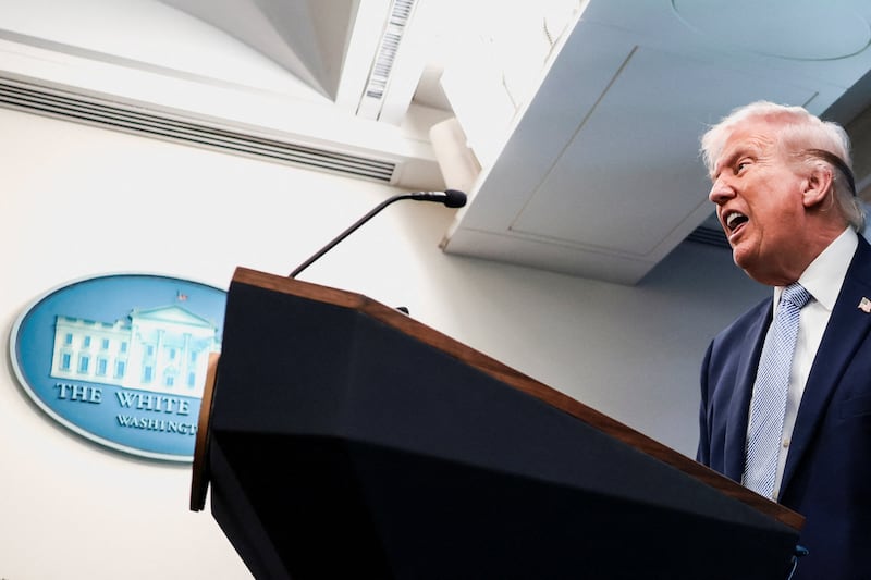 President Donald Trump answers questions from the media during a press conference.