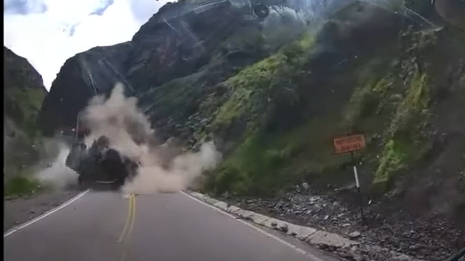 Dashcam shows trucks being totaled by boulders in a rock slide in Peru.