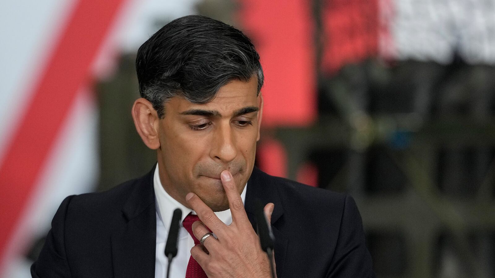 Britain's Prime Minister Rishi Sunak pauses as he addresses a press conference at the Warsaw Armoured Brigade on April 23, 2024 in Warsaw, Poland.