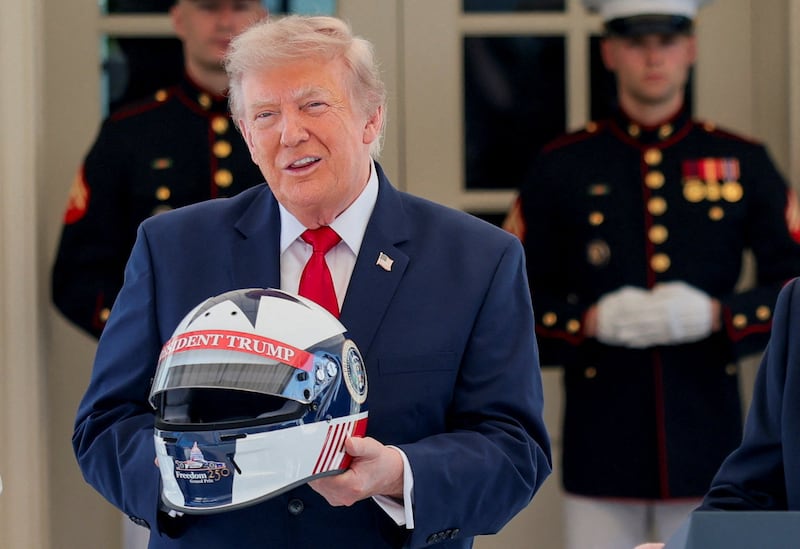 U.S. President Donald Trump reacts after being given a personalised racing helmet during a Freedom 250 Grand Prix Showcase at the White House in Washington, D.C., U.S., July 13, 2026.