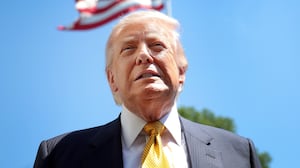 President Donald Trump speaks in front of the American flag to the press as he departs the White House on May 12, 2026 in Washington, DC.