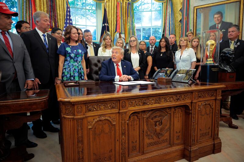 Trump displays the World Cup trophy beside a bust of Benjamin Franklin. The arrangement between the president and FIFA is unclear.
