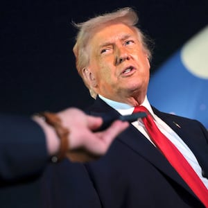 U.S. President Donald Trump (L) talks with reporters