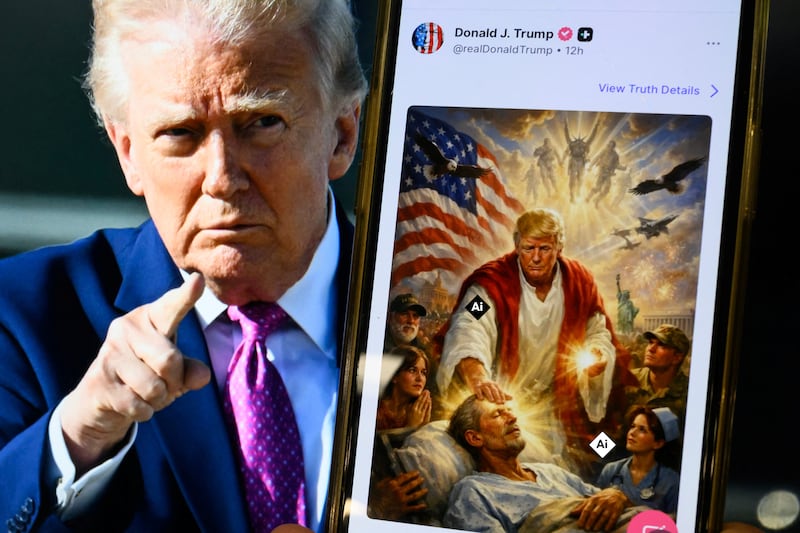 TOPSHOT - This photo illustration created on April 13, 2026 shows a picture of US President Donald Trump on a screen and an AI-generated picture he posted on his Truth Social platform depicting himself as Jesus Christ after criticizing Pope Leo XIV. Trump later posted an AI-generated image seemingly depicting himself as Jesus Christ. In the image, the president appears dressed in red and white robes as he cures a man with his healing hand. The American flag is shown over his shoulder. Trump and the White House have previously shared AI-generated images, including one that showed the president dressed as the pope. (Photo by Mandel NGAN / AFP via Getty Images)
