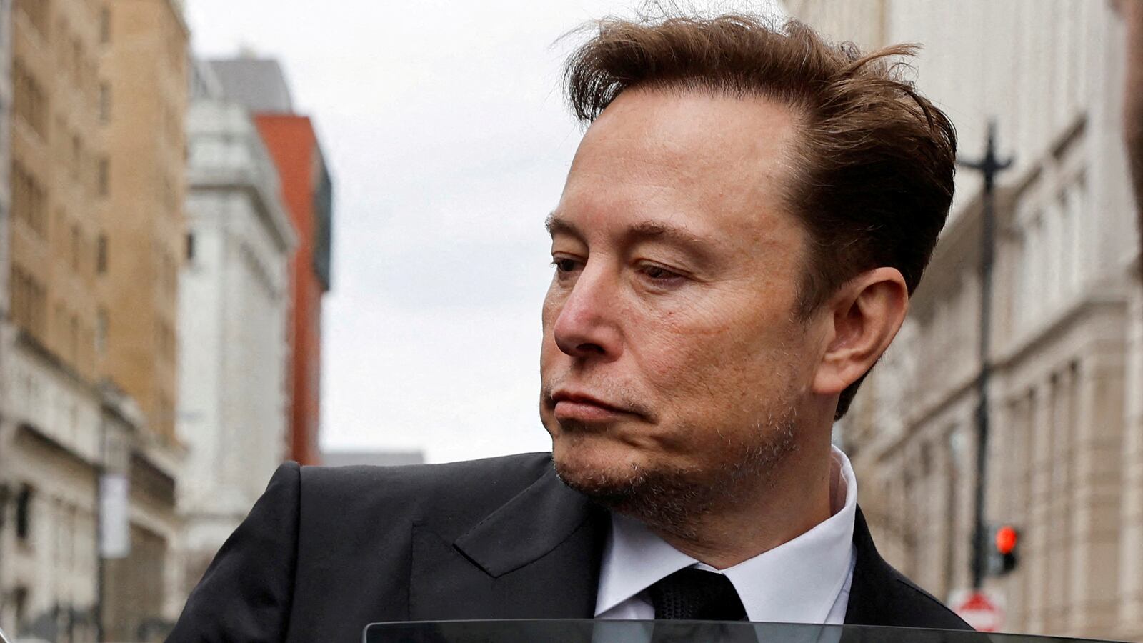 Tesla CEO Elon Musk and his security detail depart the company’s local office in Washington, U.S. January 27, 2023.