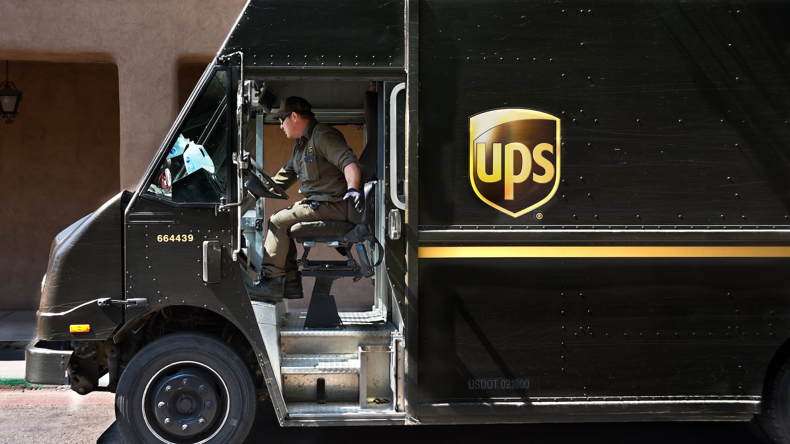 SANTA FE, NEW MEXICO - AUGUST 1, 2018: A UPS (United Parcel Service) truck driver makes a delivery in Santa Fe, New Mexico. (Photo by Robert Alexander/Getty Images)