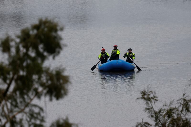 Rescuers paddle an inflatable boat as they search along a waterway following flash flooding, in Kerrville, Texas, U.S. July 6, 2025. REUTERS/Marco Bello