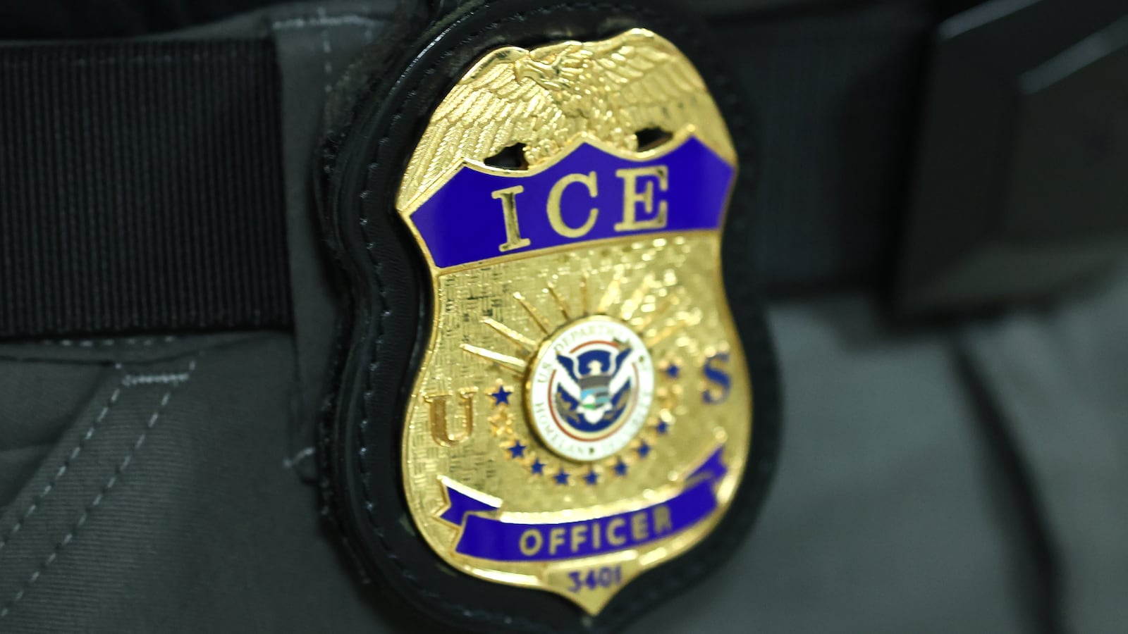 The badge of an Immigration and Customs Enforcement (ICE) agent is seen as they patrol the halls of immigration court at the Jacob K. Javits Federal Building on June 09, 2025 in New York City.