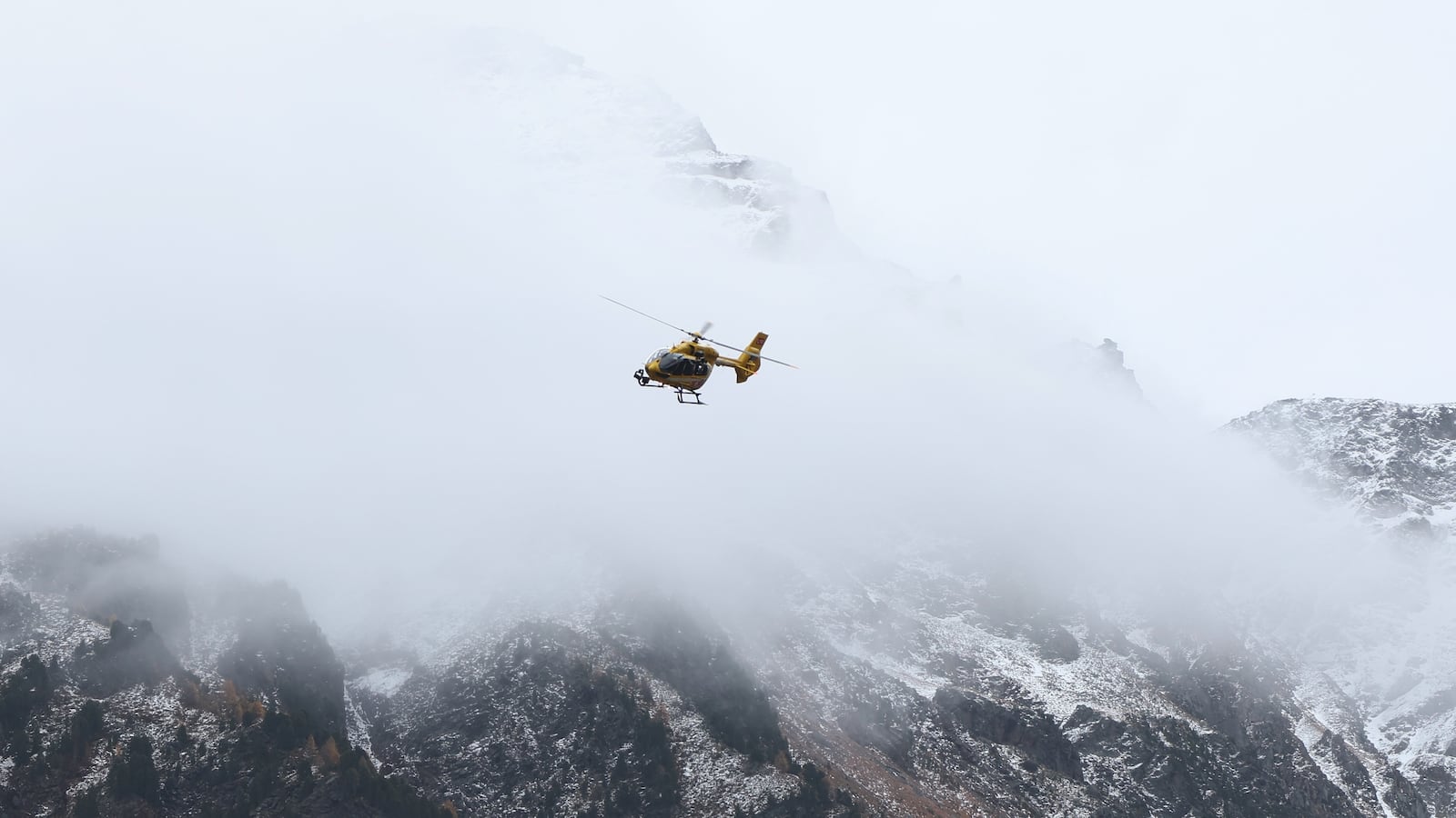 02 November 2025, Italy, Bozen: A mountain rescue helicopter flies in search of two missing mountaineers in front of the snow-covered Ortler Mountains.after the avalanche accident in South Tyrol, the bodies of the last two missing Germans have also been found. It is now certain that a total of five mountaineers died in the accident the day before - all from Germany. Photo: Karl-Josef Hildenbrand/dpa (Photo by Karl-Josef Hildenbrand/picture alliance via Getty Images)