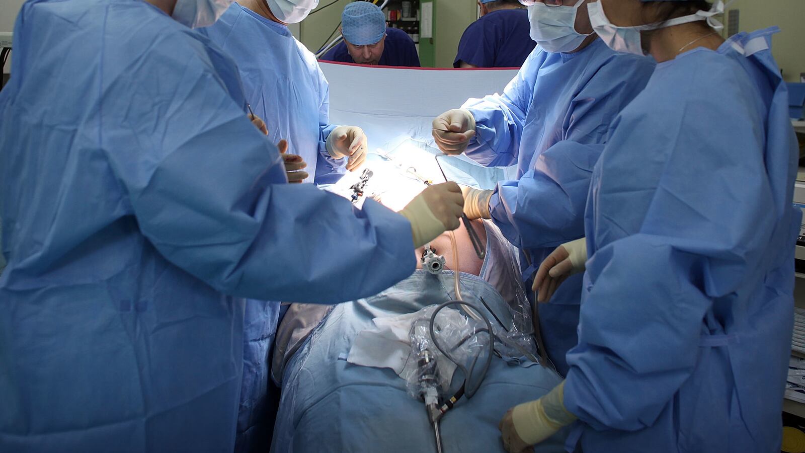 A surgeon and his theatre team perform key hole surgery
